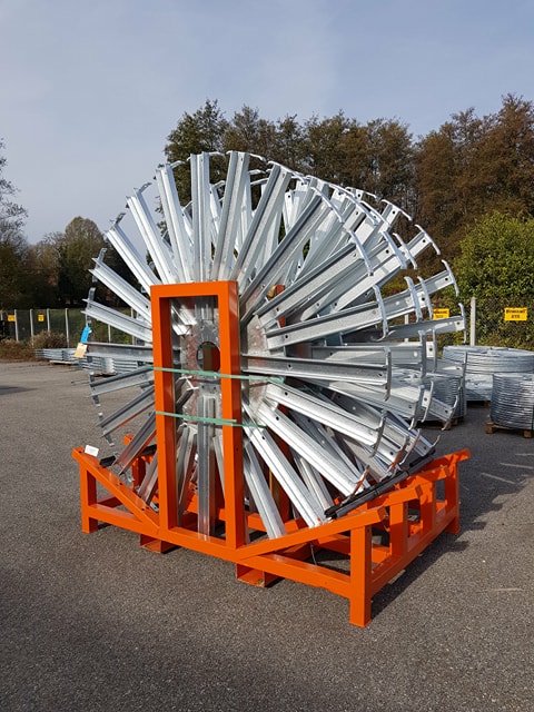 A diverse group of professionals stacking hands over a table symbolizing teamwork and collaboration.
